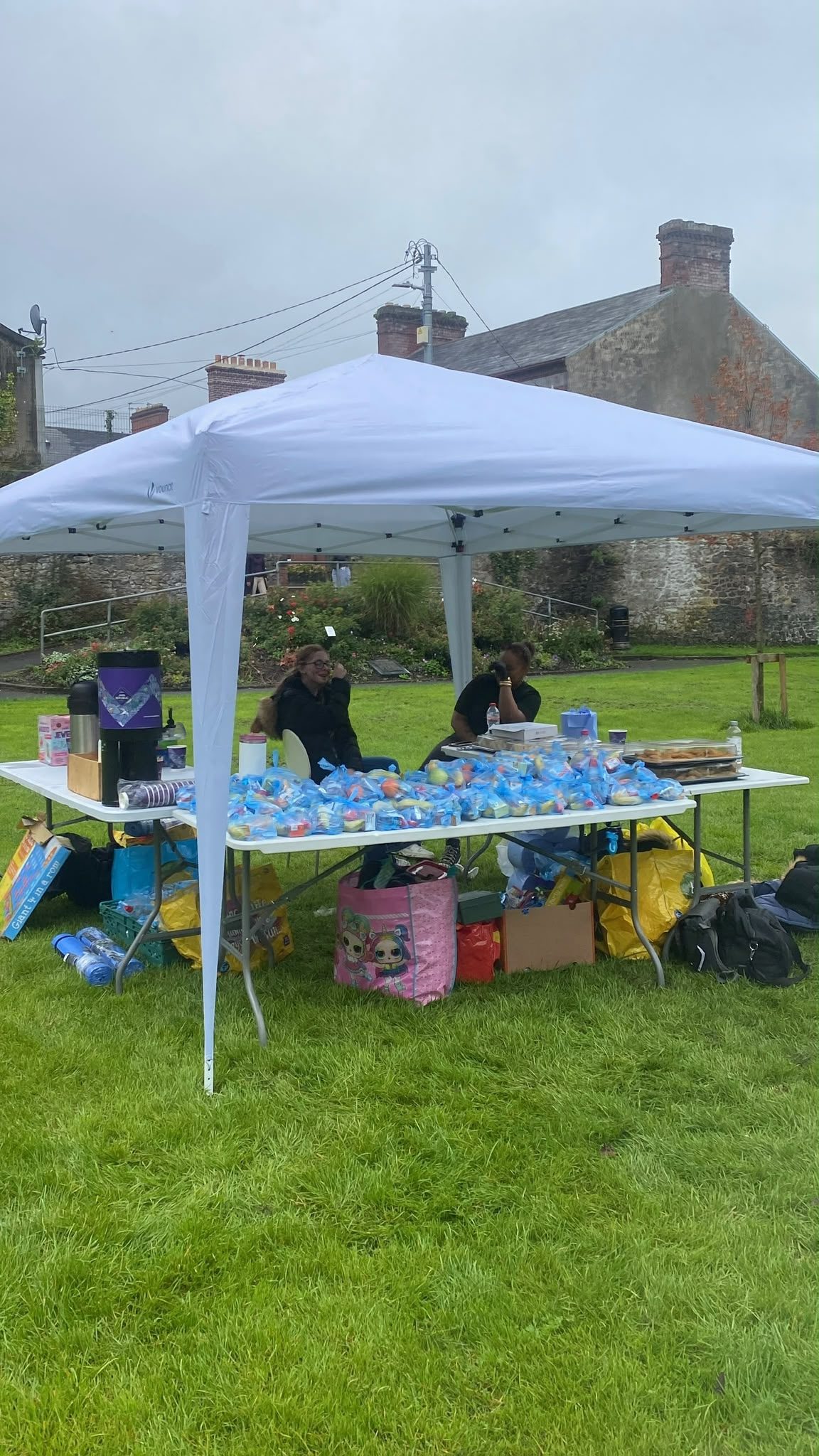 The food gazebo set up on the grass with tables of snack bags, drinks and supplies